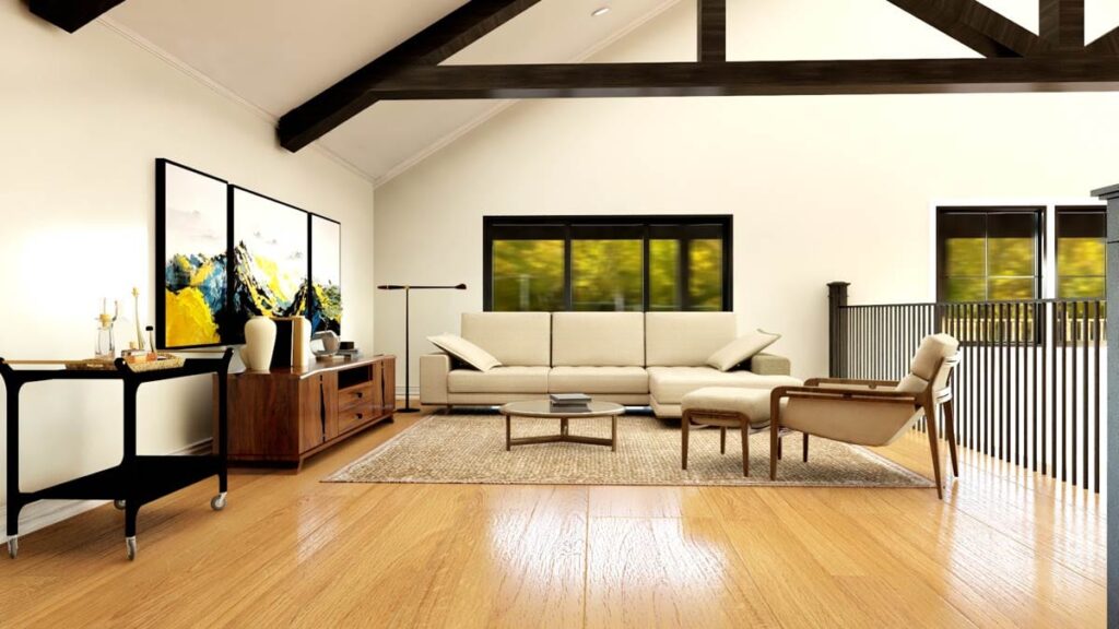 Great room with vaulted ceiling, exposed beams, sectional sofa, and large windows overlooking trees.